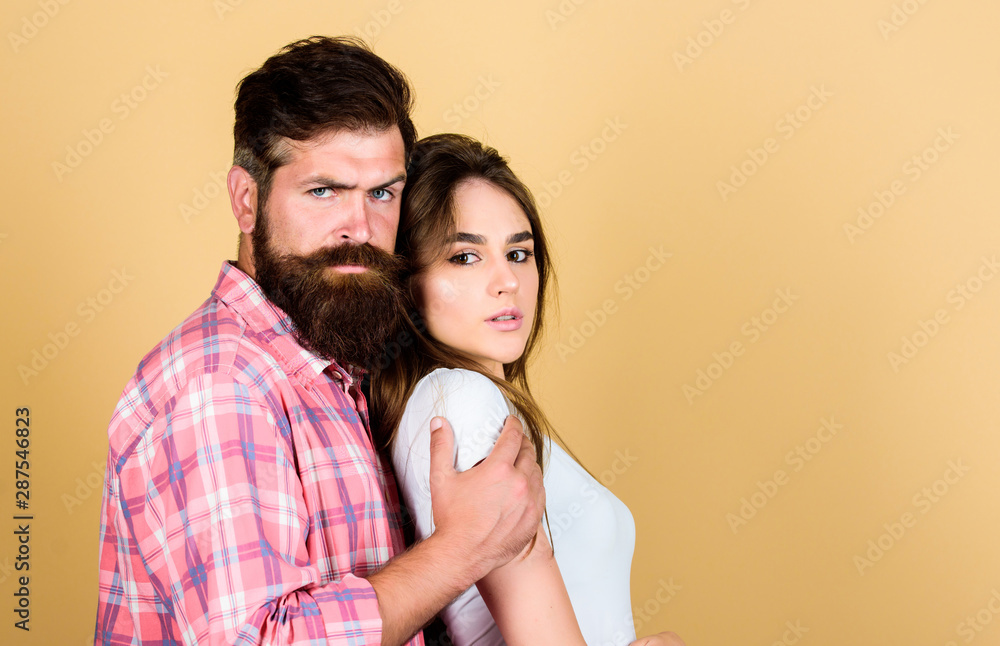 Love time. couple in love. bearded man hipster with girl. hairdresser and barber concept. male and female fashion. valentines day. sexy woman and brutal guy with beard. passion couple. copy space Love time. couple in love. bearded man hipster with girl. hairdresser and barber concept. male and female fashion. valentines day. sexy woman and brutal guy with beard. passion couple. copy space
