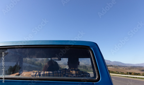 Rear view of couple in truck on highway