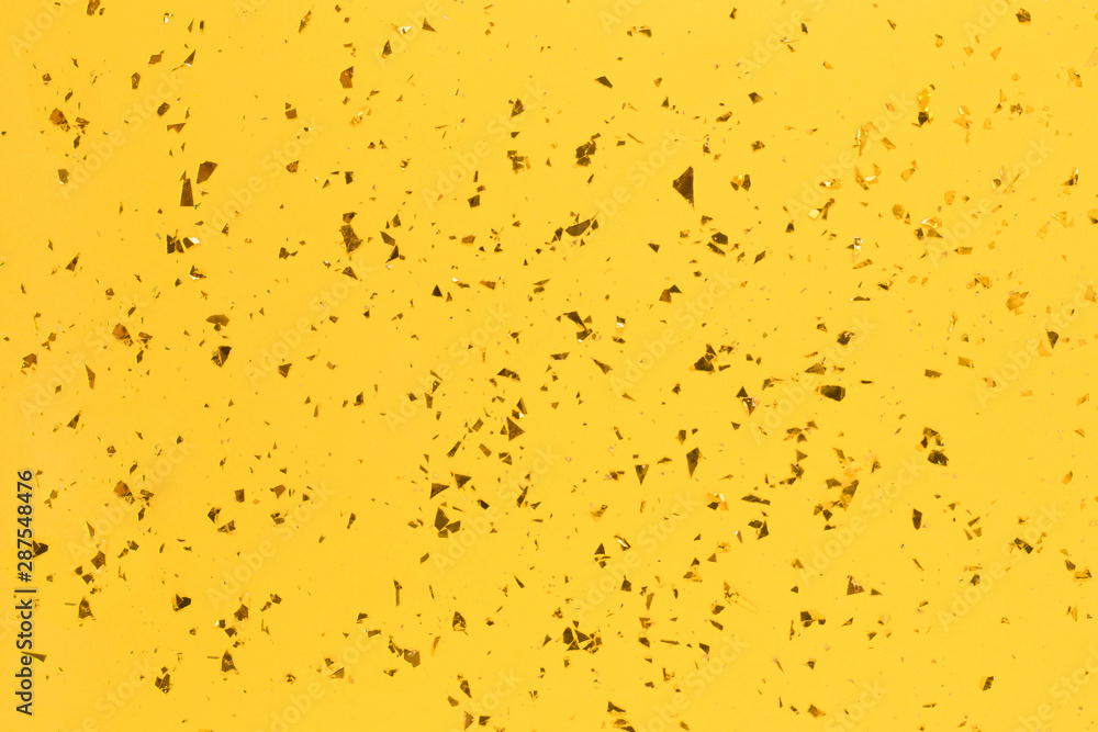 Golden sparkles on bright yellow trendy background. Golden sparkles on bright yellow trendy background.