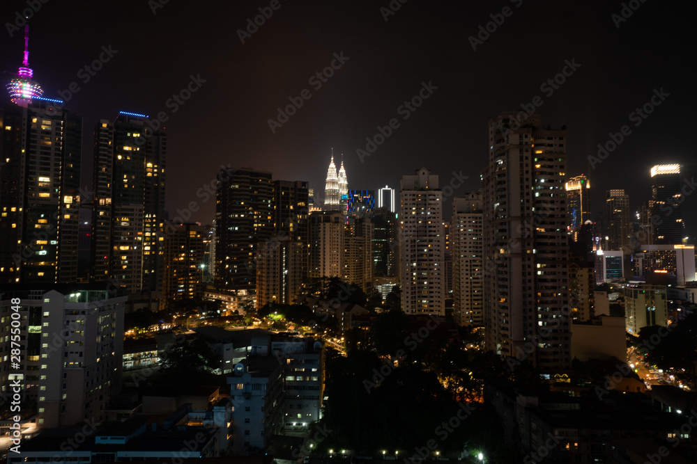 Aerial drone view of Kuala Lumpur city skyline at night, Malaysia
