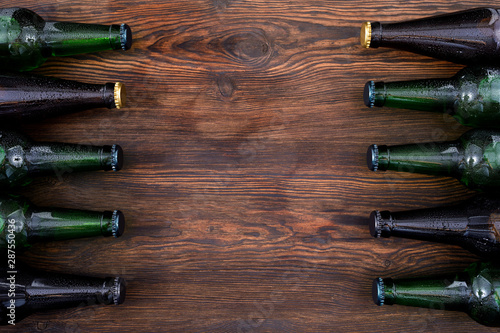 different beer bottles on wooden table . Top view