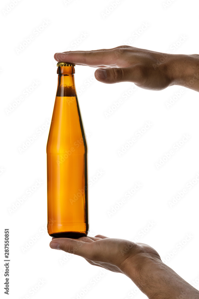 male hand holding brown beer bottle without label isolated on white background