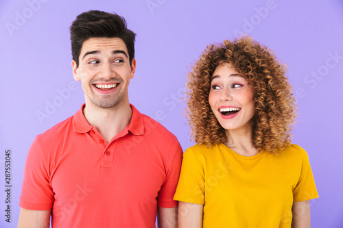 Portrait of pretty caucasian people man and woman in basic clothing smiling and looking at each other