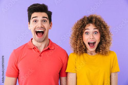 Portrait of excited caucasian people man and woman in basic clothing screaming together at camera