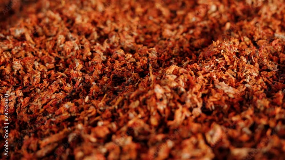 View of a male hand passing over sea buckthorn being dried to prepare tea View of a male hand passing over sea buckthorn being dried to prepare tea