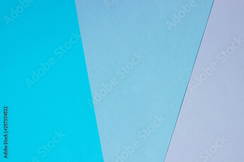 Abstract geometric flat background from colored paper. Violet and blue colored paper, template for adding text.