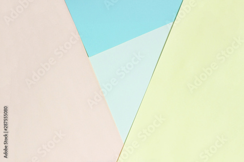 Abstract geometric flat background from colored paper. Yellow and blue colored paper, a template for adding text.