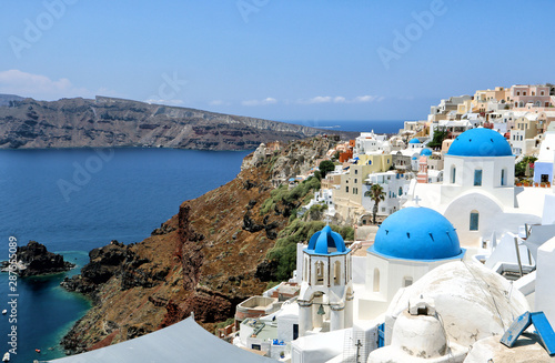 The blue domes and white buildings of Santorini looking over the blue Aegean Sea, Greek Islands
