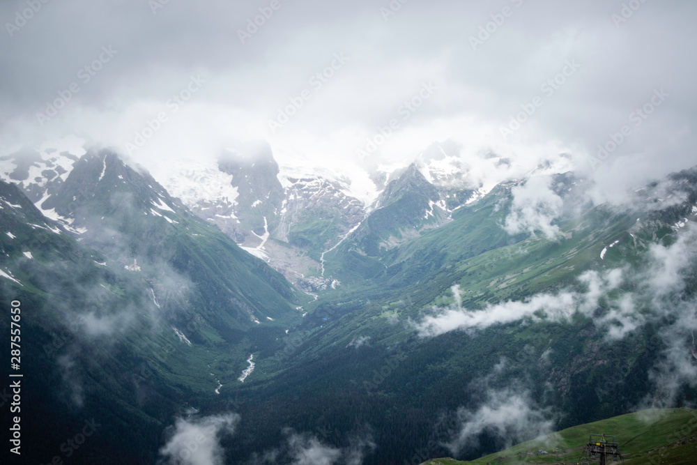 mountain landscape - mountains forest, rocks glaciers snow clouds, Dombay, Karachay-Cherkessia, Russia mountain landscape - mountains forest, rocks glaciers snow clouds, Dombay, Karachay-Cherkessia, Russia