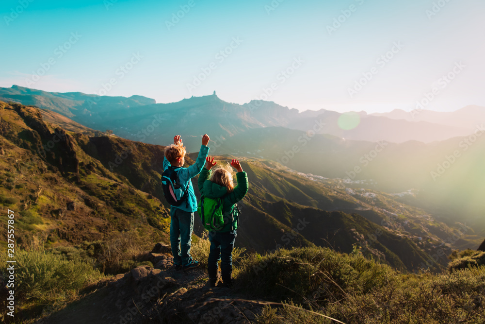 happy boy and girl travel in mountains at sunset, kids enjoy hiking happy boy and girl travel in mountains at sunset, kids enjoy hiking
