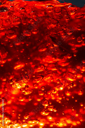 Alcoholic drink on dark background, abstract splashing.