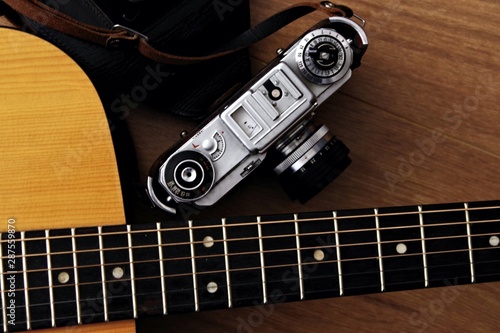 acoustic classic gutar neck with vintage film camera photo