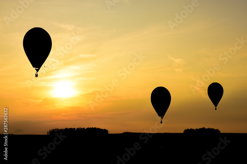 Hot air balloons in the sky flying at sunset