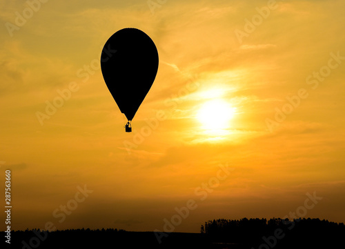 Hot air balloons in the sky flying at sunset