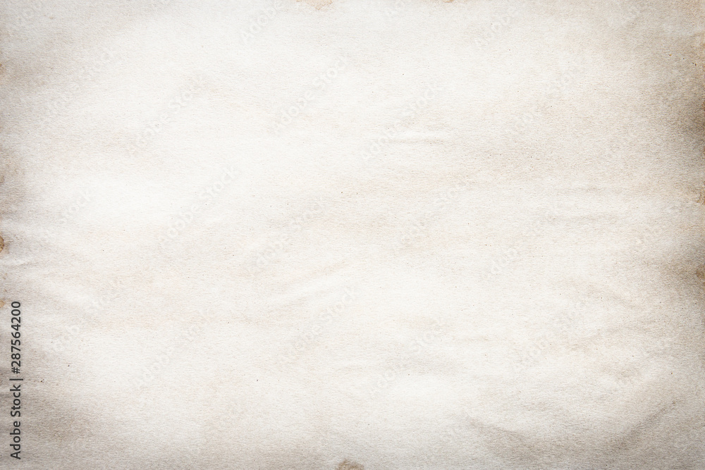 Old brown and white paper stained with coffee. Vintage abstract background. Old brown and white paper stained with coffee. Vintage abstract background.