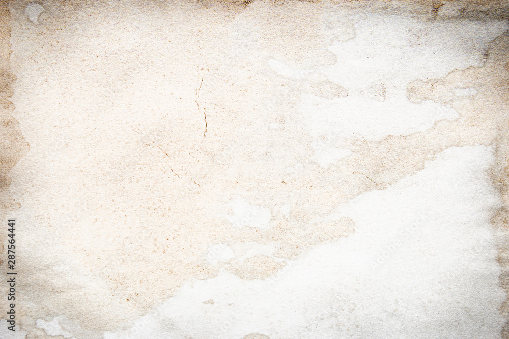 Fototapeta premium Old brown and white paper stained with coffee. Vintage abstract background.