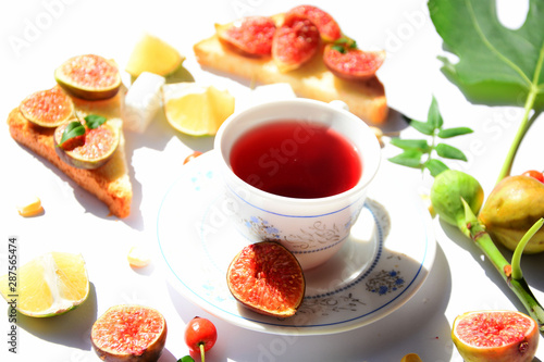 cup of tea and cake with fruits and berries