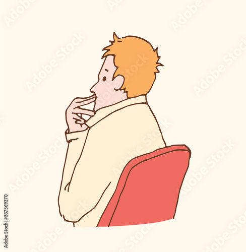 Man sits in a theater chair and listening. Spectator view film of spectacle. Viewer is watching the show. Thinking man in pastel colors. Сritic evaluates something. Portrait of audience in room. 