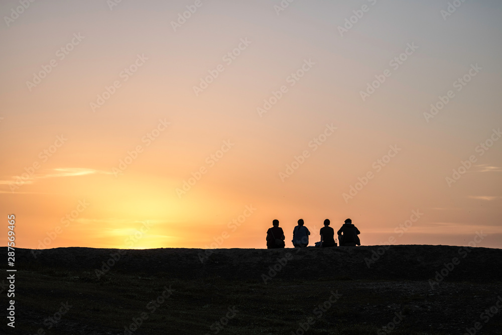 Silhouttes in sunset on hill