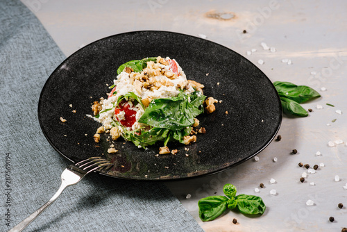 Fresh tasty green salad on the wooden background