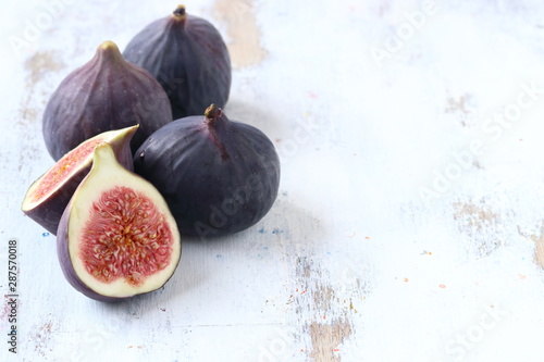 Fig fruit on a white woode nbackground photo
