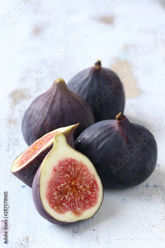 Fig fruit on a white woode nbackground photo