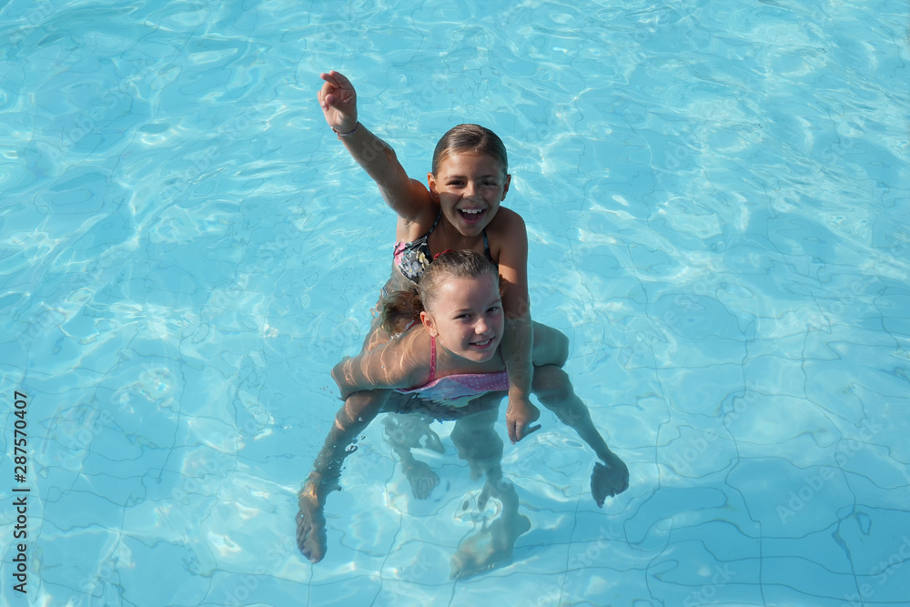Cheerful kids at the swimming-pool