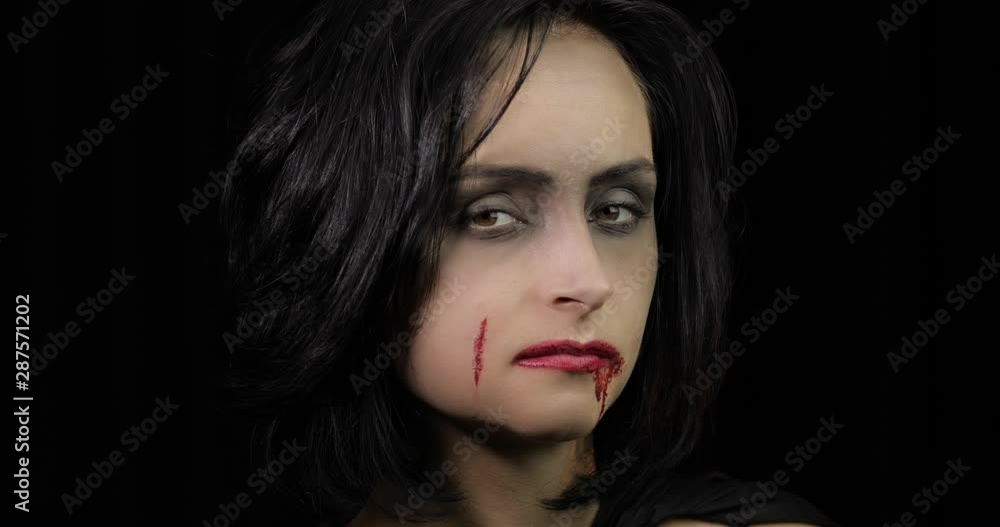 Vampire Halloween makeup. Woman portrait with blood on her face. Vampire Halloween makeup. Woman portrait with blood on her face.