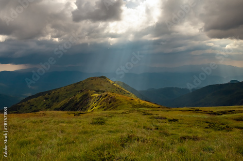 Storm clouds and sun rays over the mountains