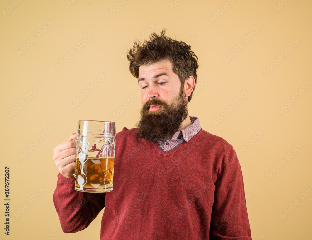 Bad habits. Stylish man with beard holds mug of beer. Drinks, alcohol, leisure and people concept. Bearded man drinking beer from glass at bar or pub. Bearded drunk hipster male holds craft beer. Bad habits. Stylish man with beard holds mug of beer. Drinks, alcohol, leisure and people concept. Bearded man drinking beer from glass at bar or pub. Bearded drunk hipster male holds craft beer.
