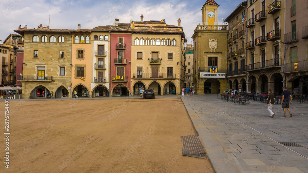 Vic Catalonia Spain Placa Major Main Square . Golden light. Summer time. People walking streets