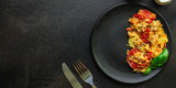scrambled eggs with tomatoes - breakfast delicious and healthy, menu concept. food background. copy space