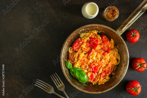 scrambled eggs with tomatoes - breakfast delicious and healthy, menu concept. food background. copy space