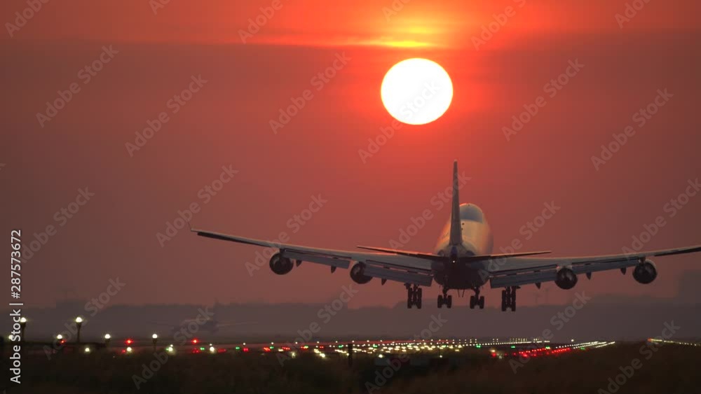 Big airplane landing at beautiful sunrise Big airplane landing at beautiful sunrise