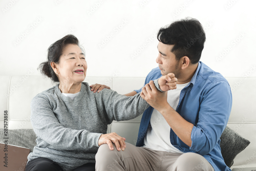 Asian man massage his mother at home, lifestyle concept. Asian man massage his mother at home, lifestyle concept.