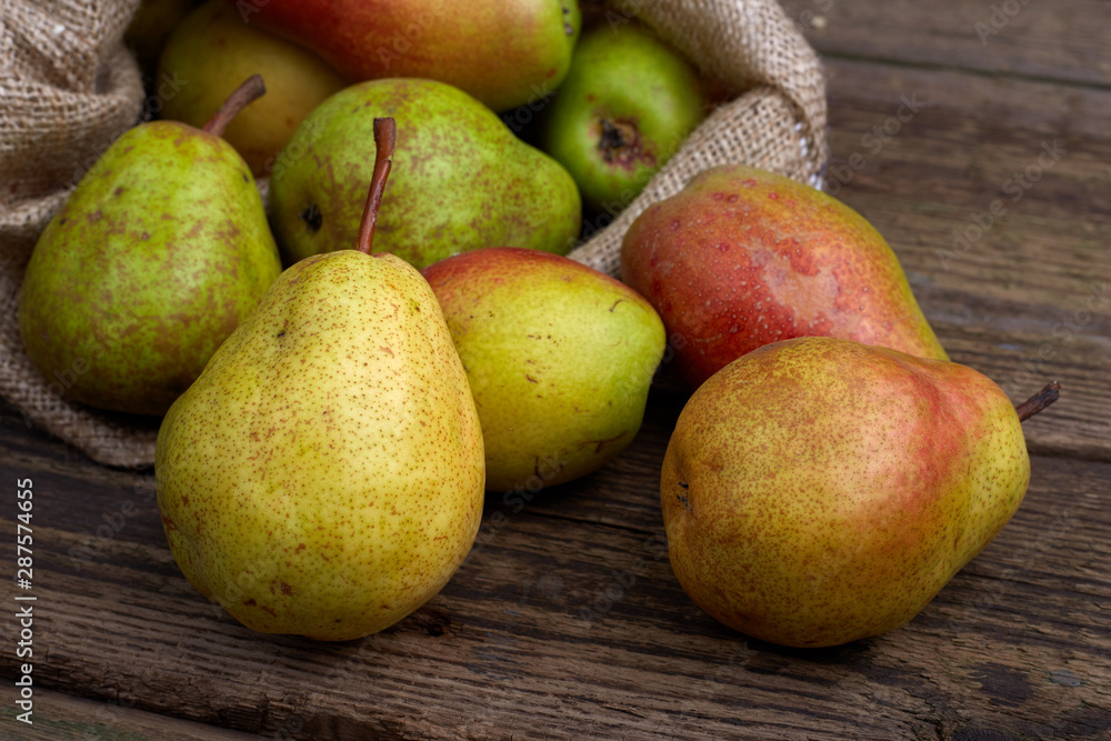 Ripe juicy pears on brown wooden table, flat lay. Space for text Ripe juicy pears on brown wooden table, flat lay. Space for text