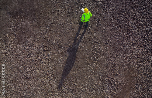 Construction worker from above on gravel photographed photo