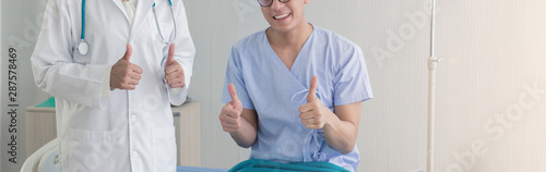 Photos Young Asian beautiful doctor and Asian teenage patient showing thumbs up with smiley face in the hospital