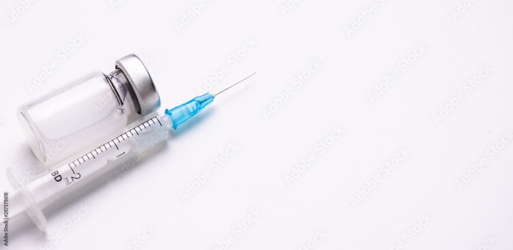 Flu shot, HPV, measles vaccine vials dose injection with syringe and needle isolated on white background (select focus) Flu shot, HPV, measles vaccine vials dose injection with syringe and needle isolated on white background (select focus)