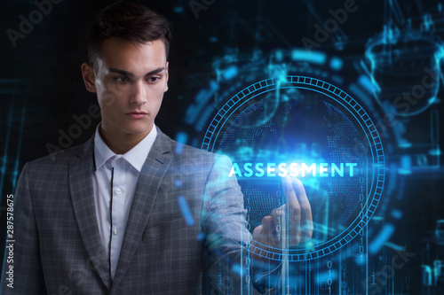 The concept of business, technology, the Internet and the network. A young entrepreneur working on a virtual screen of the future and sees the inscription: Assessment