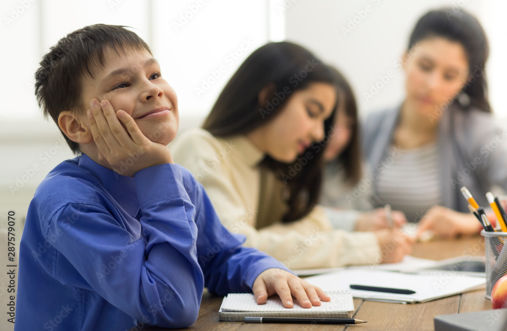Dreamful pupil not paying attention in classroom Dreamful pupil not paying attention in classroom