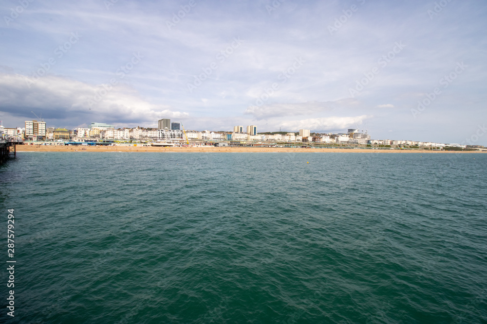 Brighton UK, 10th July 2019: The famous beautiful Brighton Beach and Seafront showing the coastline area on a bright sunny day,