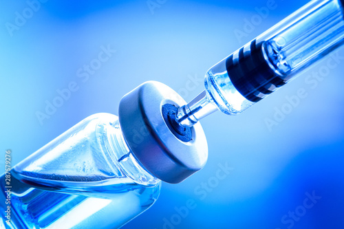 Flu shot, HPV, measles vaccine vials dose injection with syringe and needle isolated on white background (select focus) photo