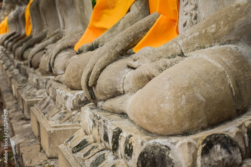 Statues of Buddha sitting in a row at Wat Chai Mongkol in Ayutthaya, Thailand