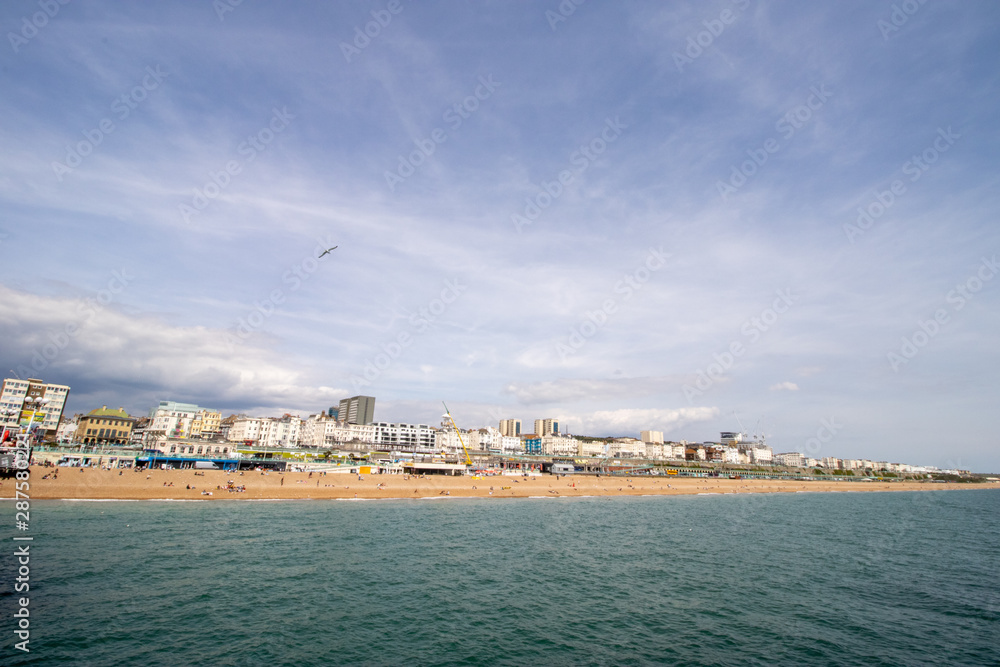 Naklejka premium Brighton UK, 10th July 2019: The famous beautiful Brighton Beach and Seafront showing the coastline area on a bright sunny day,