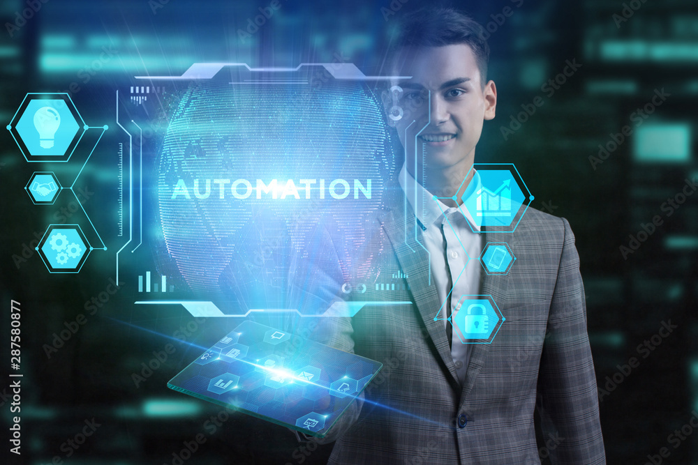 The concept of business, technology, the Internet and the network. A young entrepreneur working on a virtual screen of the future and sees the inscription: Automation The concept of business, technology, the Internet and the network. A young entrepreneur working on a virtual screen of the future and sees the inscription: Automation