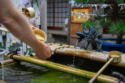 The ladles for water in a ritual hand-washing well, Kyoto , Japan
