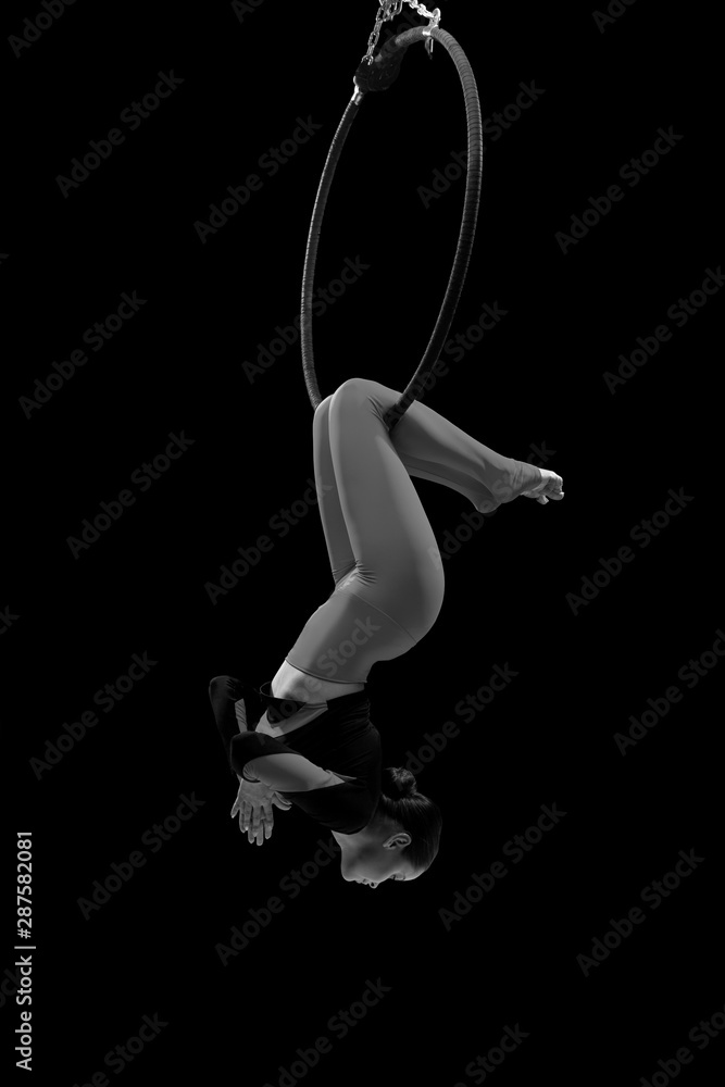 A female gymnast performing exercises on an air ring (hoop) A female gymnast performing exercises on an air ring (hoop)