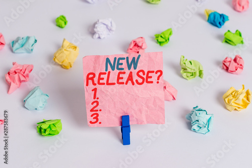 Conceptual hand writing showing New Release Question. Concept meaning asking about recent product or service newly unleashed Colored crumpled paper empty reminder white floor clothespin © Artur