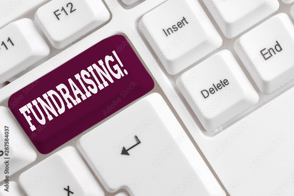 Writing note showing Fundraising. Business concept for seeking to generate financial support for charity or cause White pc keyboard with note paper above the white background Writing note showing Fundraising. Business concept for seeking to generate financial support for charity or cause White pc keyboard with note paper above the white background